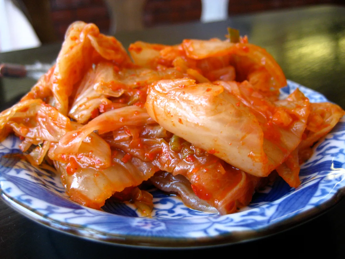 A plate of napa cabbage kimchi, seasoned with red chili paste.