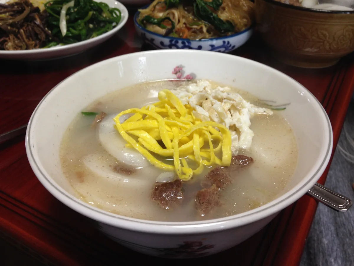 A bowl of tteokguk, sliced rice cake soup traditionally eaten on Seollal.