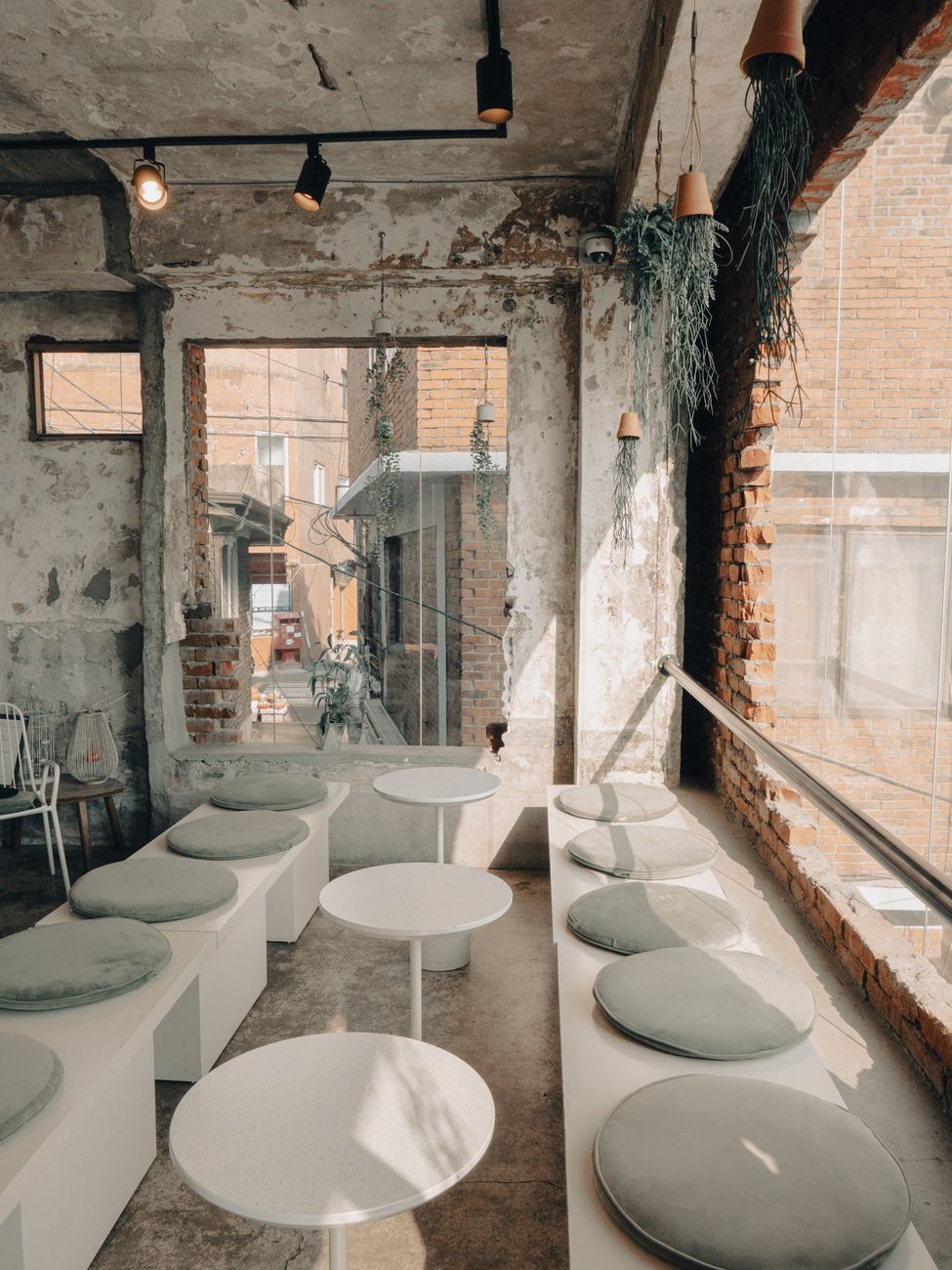 Bright industrial-style café in Seoul, featuring modern seating and rustic elements.