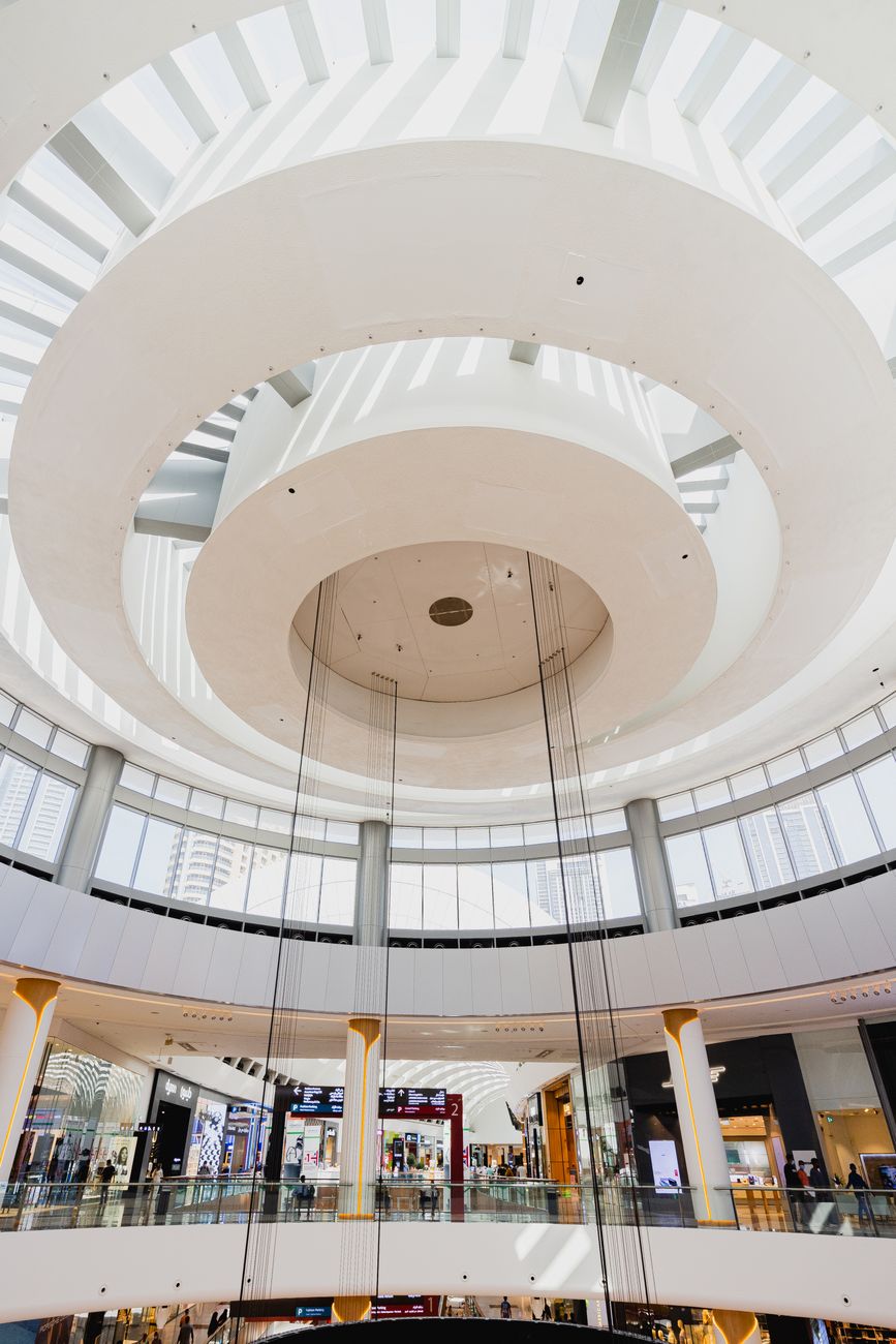 High ceiling and modern design of a futuristic shopping mall interior space.