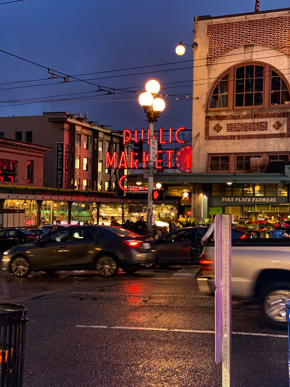 Vibrant evening scene at Seattle's iconic Pike Place Market, a bustling urban landmark.