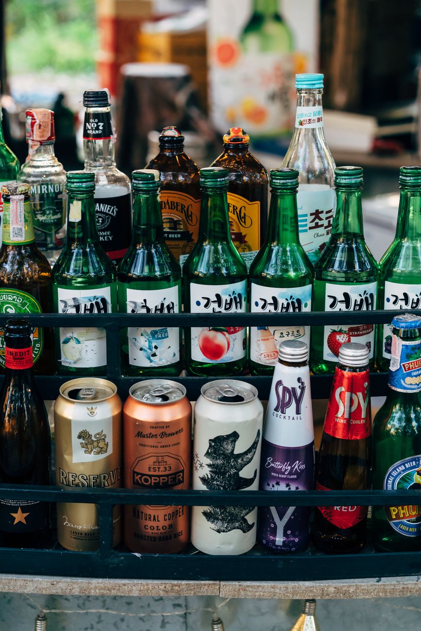 A vibrant display of assorted beverage bottles and cans, perfect for a bar setting.