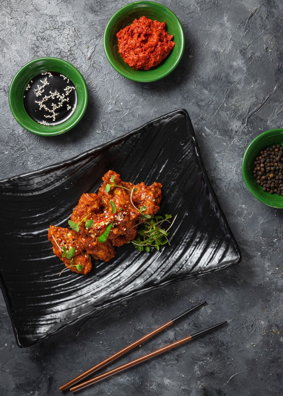 Delicious spicy Korean chicken dish served with soy sauce & gochujang.