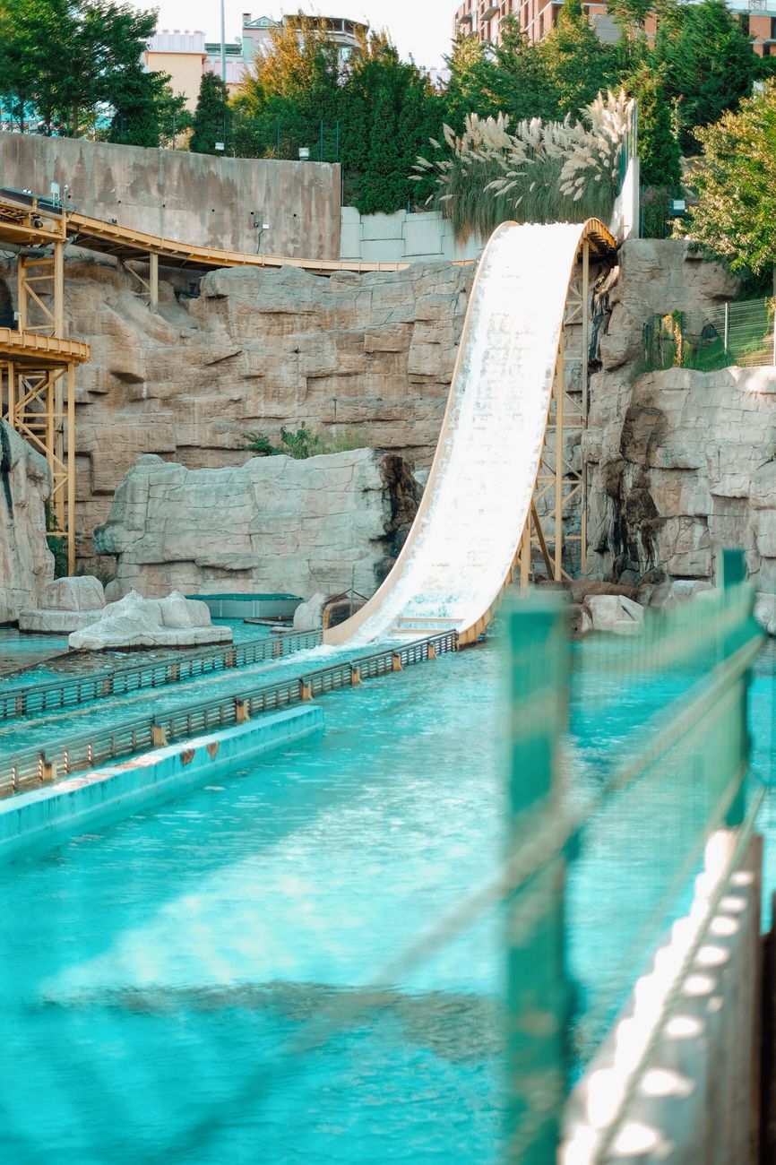 Steep water slide in a summer amusement park offering fun and adventure.