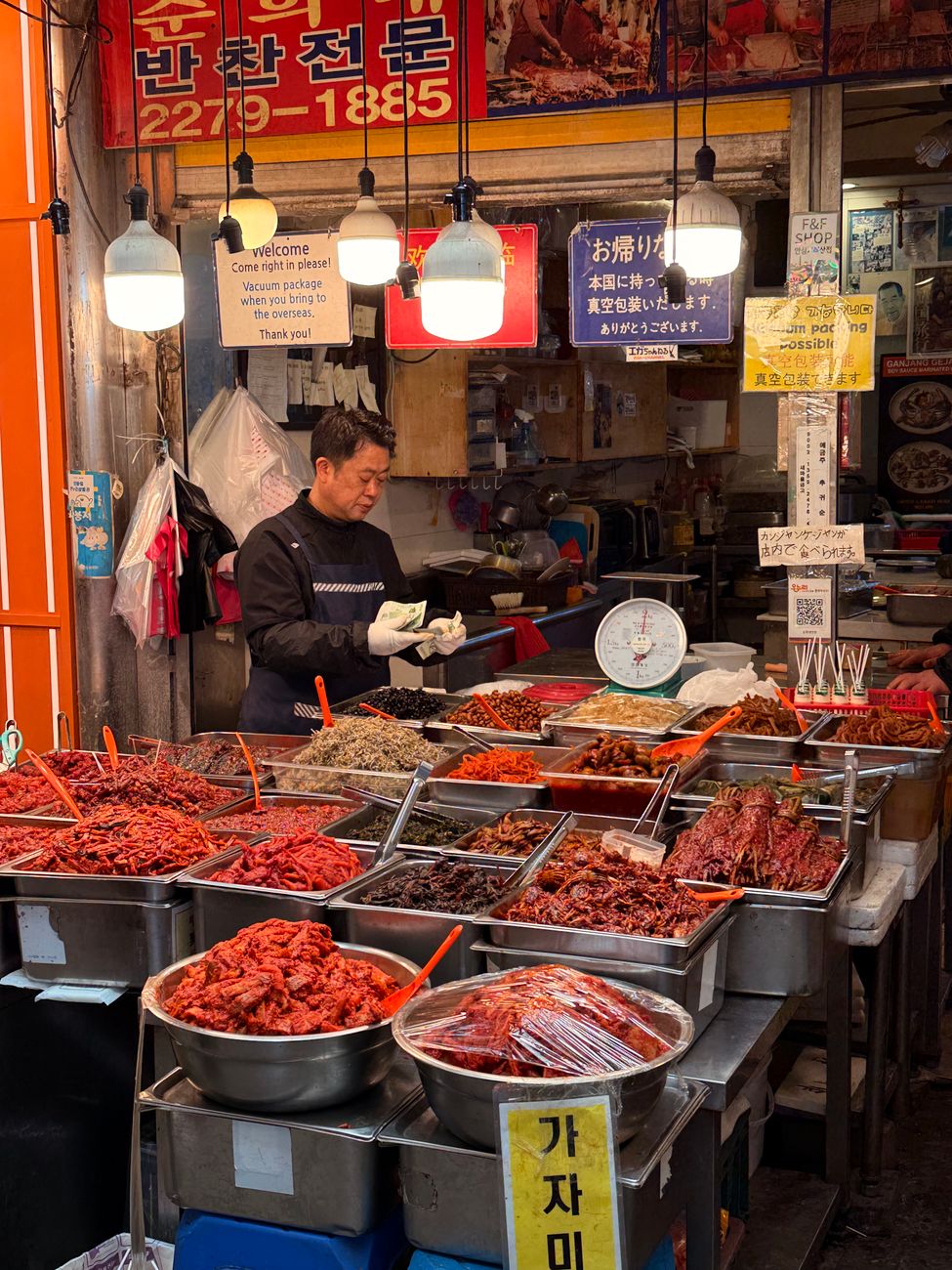 A vibrant Korean market stall displaying a variety of dried seafood and produce, captured in South Korea.