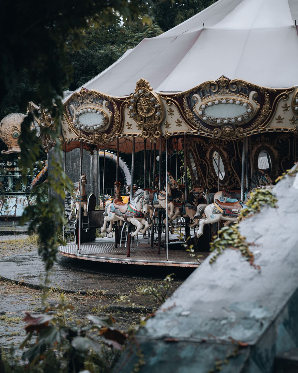 A vintage carousel with ornate details stands abandoned at Yongma Land, Seoul.