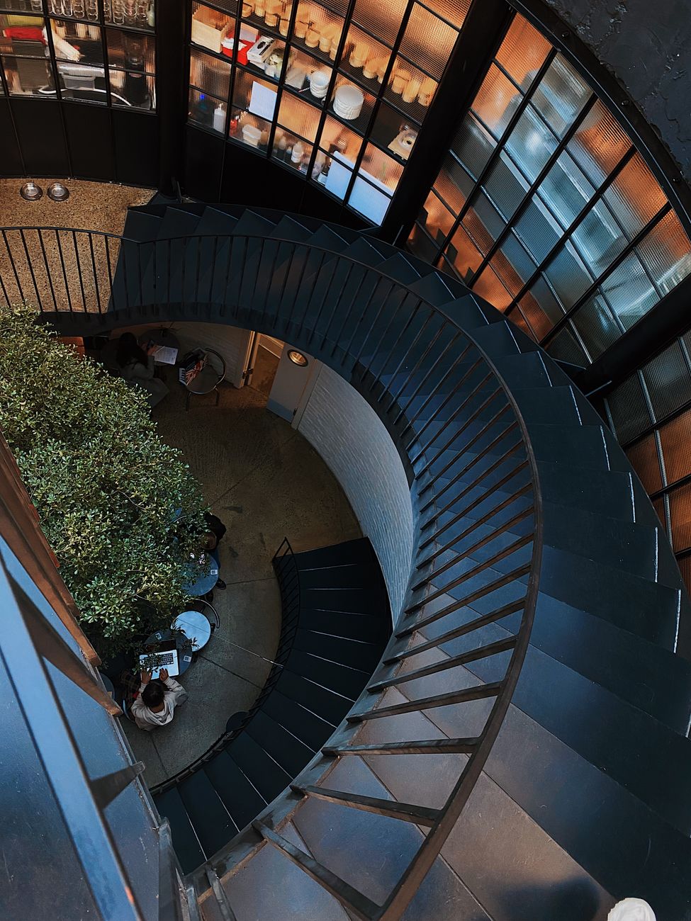 High-angle view of a modern spiral staircase inside a stylish building in Kyiv, Ukraine.