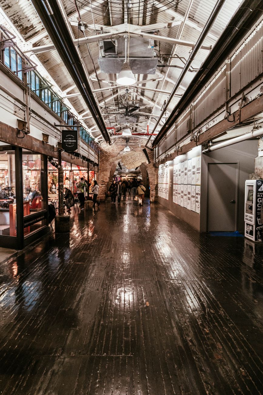 Explore the bustling interior of Chelsea Market, capturing vibrant shops and visitors in New York City.