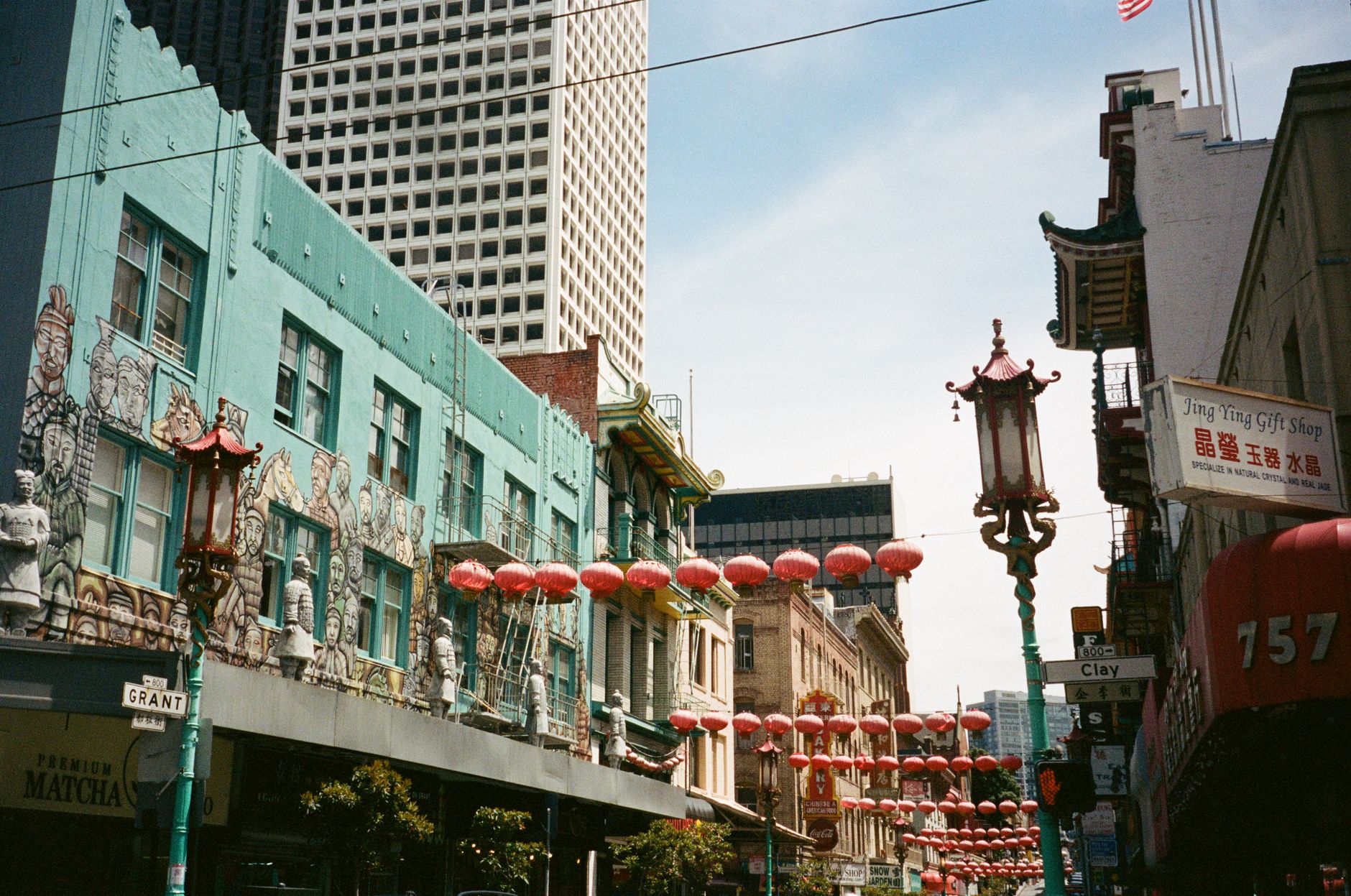 Vibrant Chinatown street in San Francisco with hanging lanterns and bustling atmosphere.