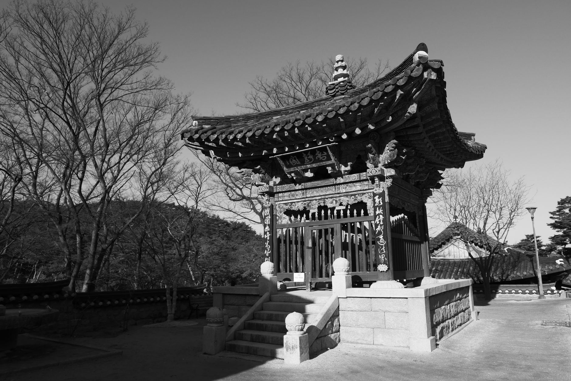 Monochrome photo of a traditional Korean temple structure in outdoor setting.
