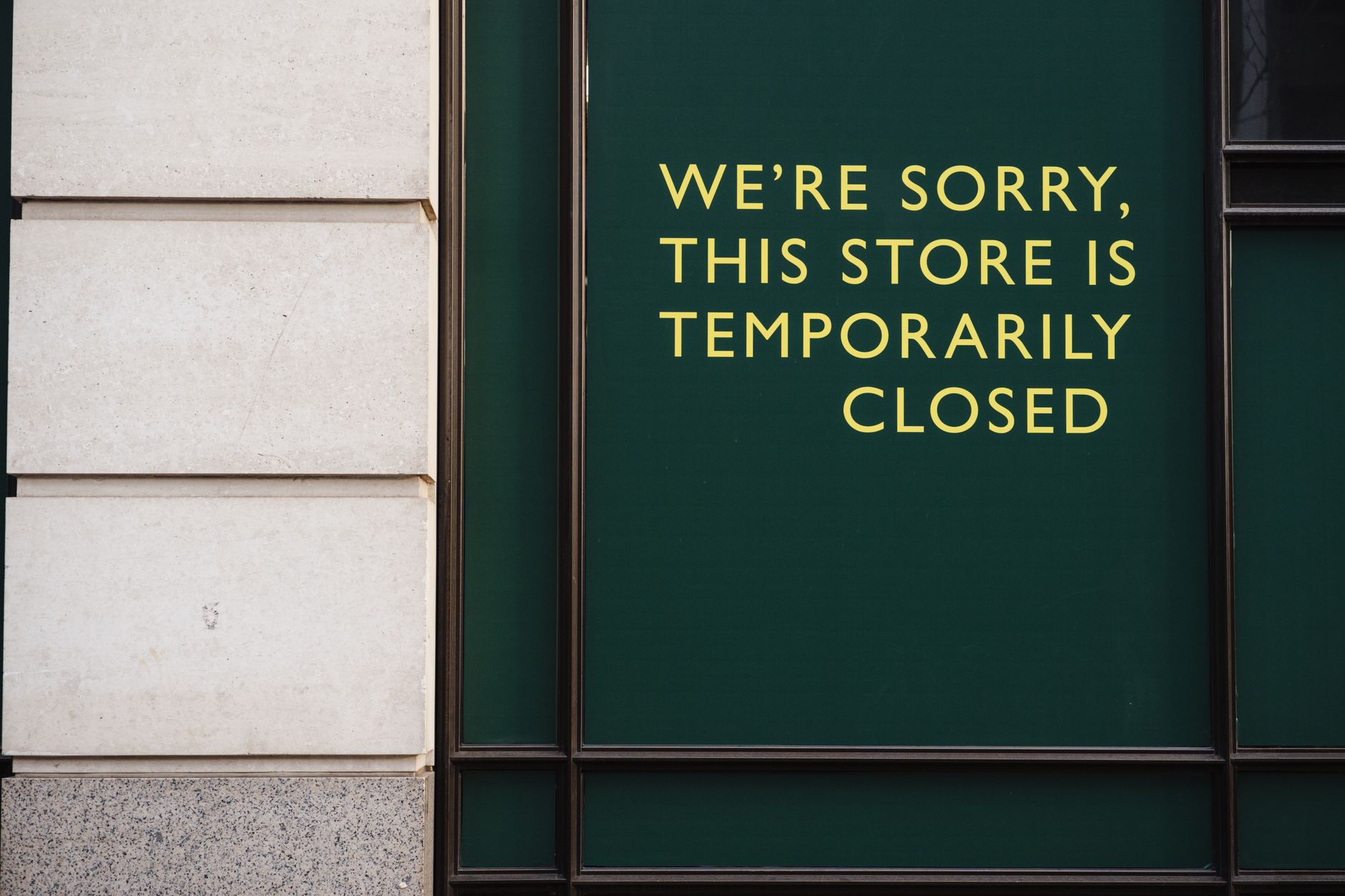 A photo of a store facade with a sign indicating temporary closure due to unforeseen circumstances.