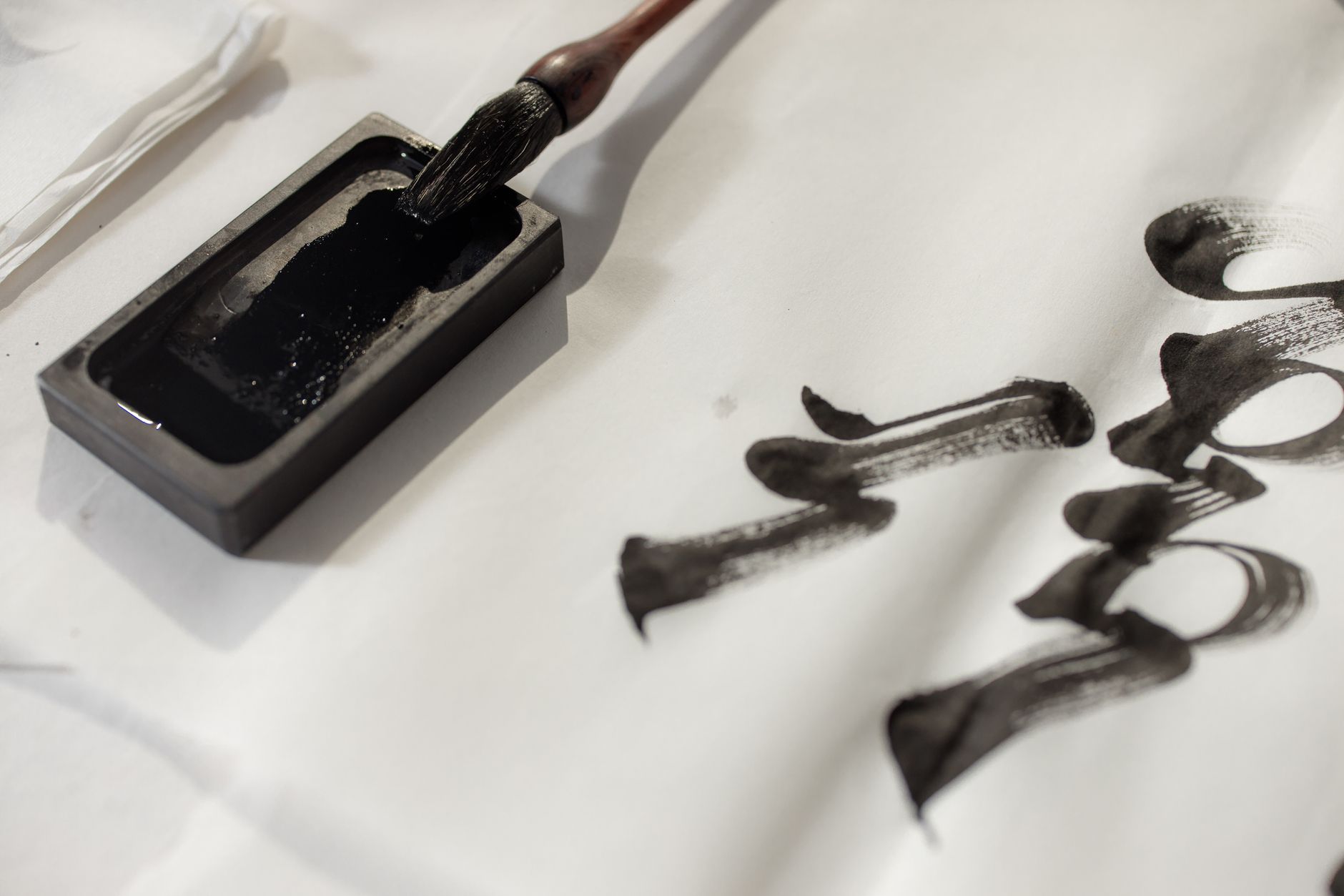 Close-up of traditional calligraphy ink and brush, illustrating artistic expression.