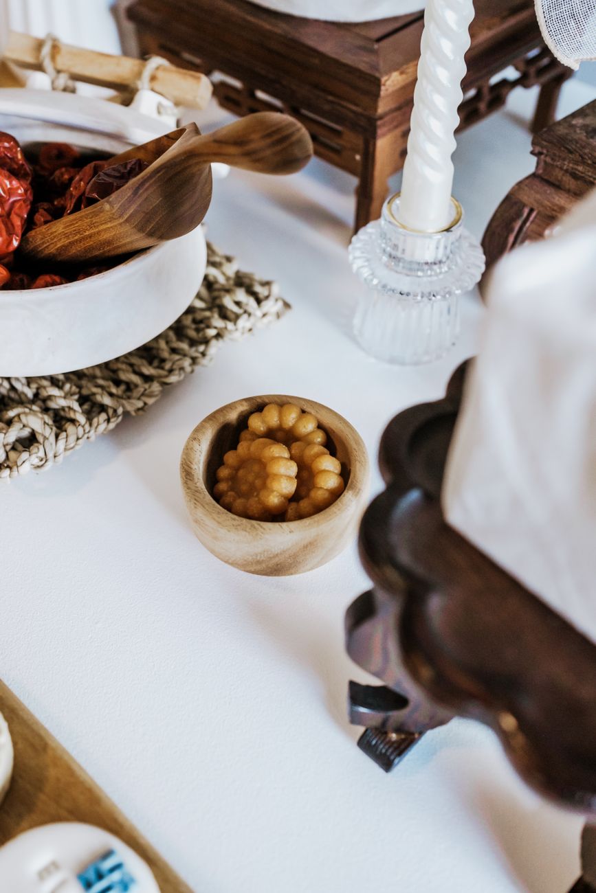 Close-up of a Korean table setting featuring a candle and traditional items, perfect for cultural celebrations.