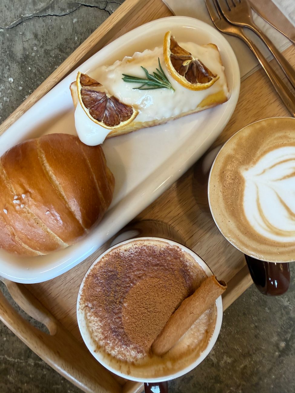 A tasty assortment of pastries and coffee in a stylish Korean cafe setting.