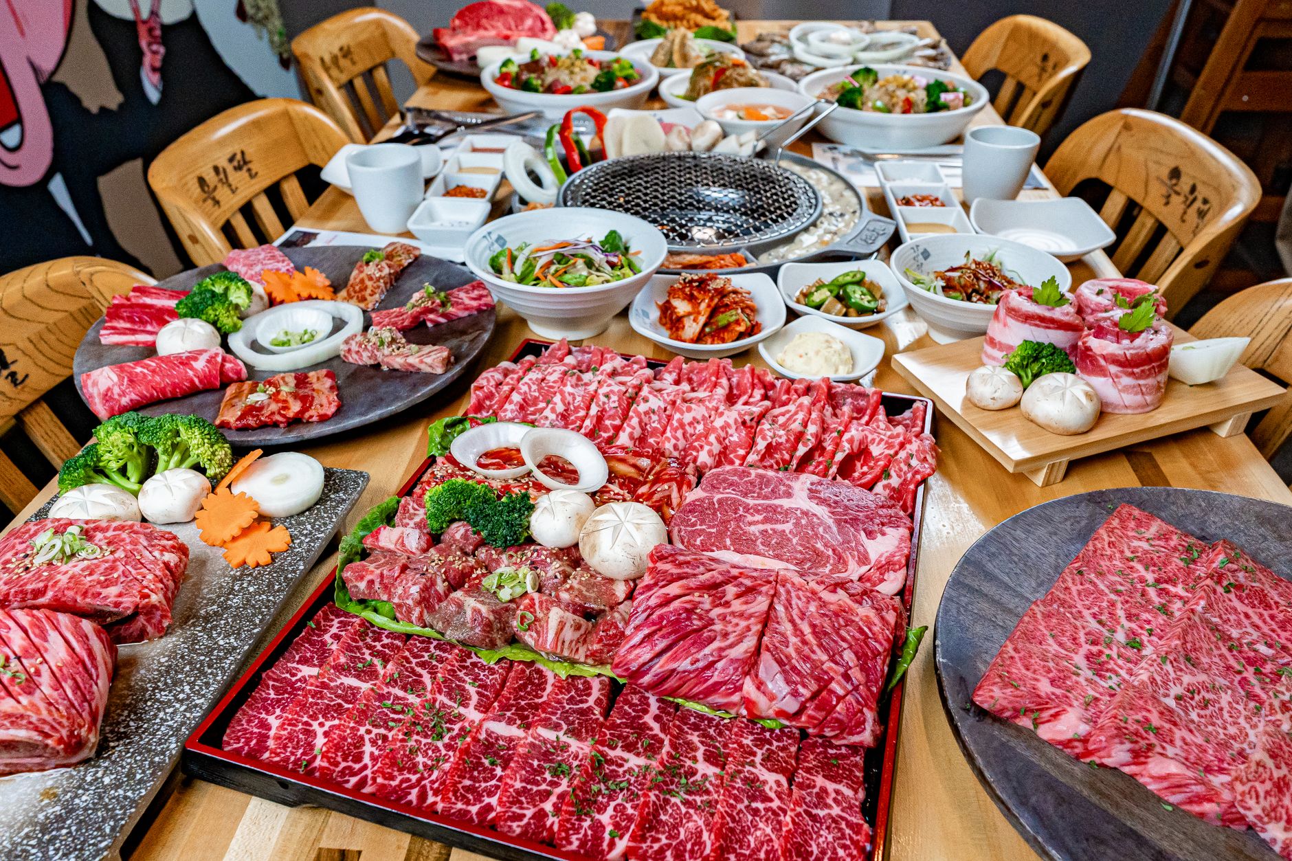 An array of fresh Korean BBQ meats and side dishes, ready for grilling and enjoyment.