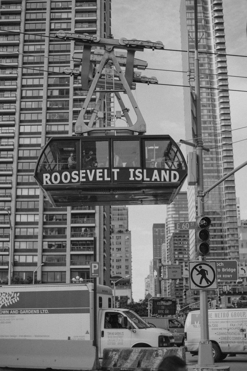 Black and white image of the Roosevelt Island Tramway against New York City's iconic skyline.