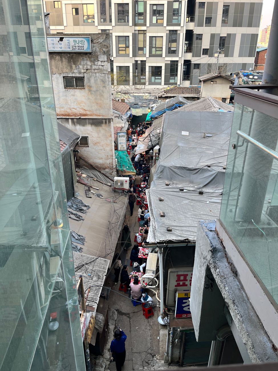 A vibrant market alley in Euljiro, Seoul captures daily life amidst urban structures.