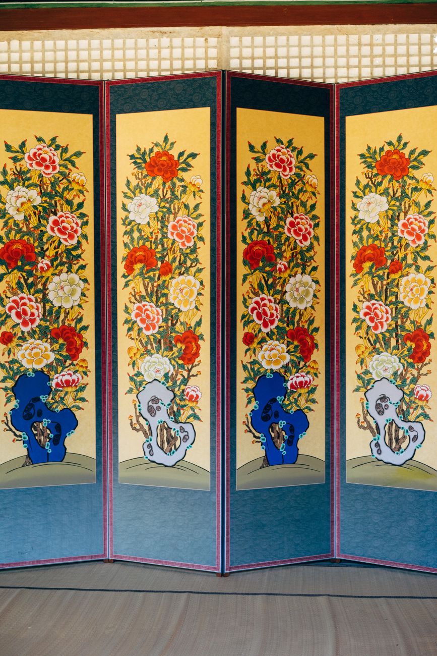 Elegant Korean folding screen featuring vibrant floral patterns in Seoul house.