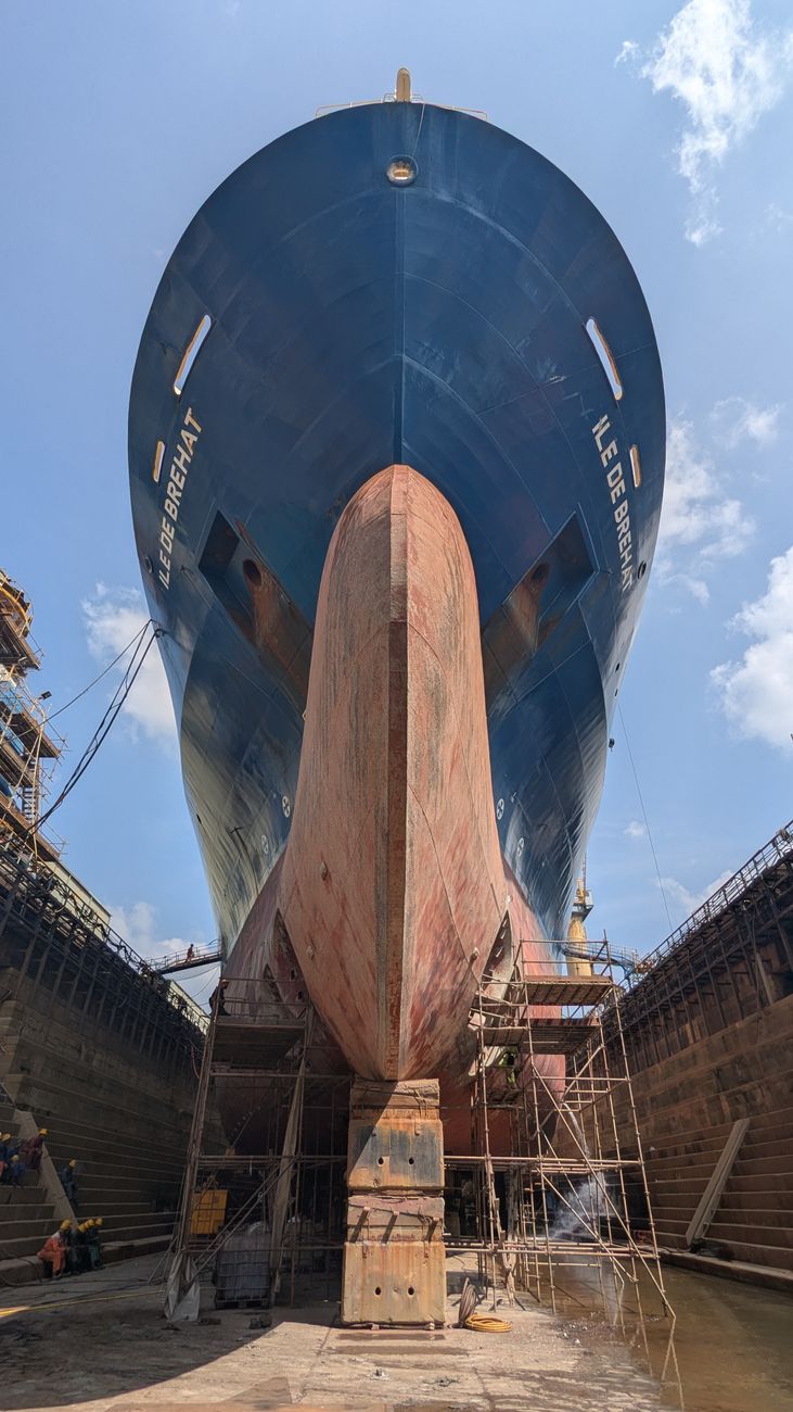 Impressive view of a large ship hull in a Sri Lankan dry dock, showcasing maritime engineering.